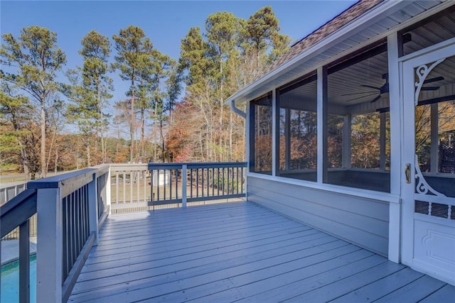 deck with a sunroom and ceiling fan