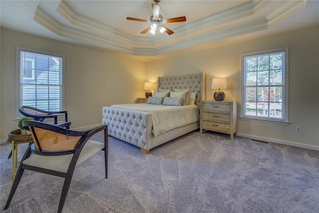 bedroom featuring light carpet, a raised ceiling, and ceiling fan