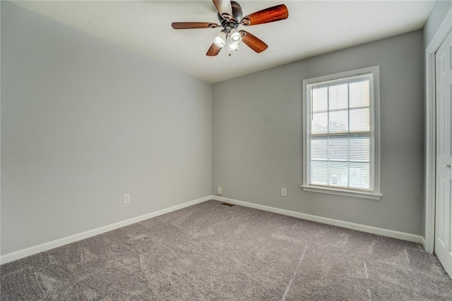 spare room with carpet and ceiling fan