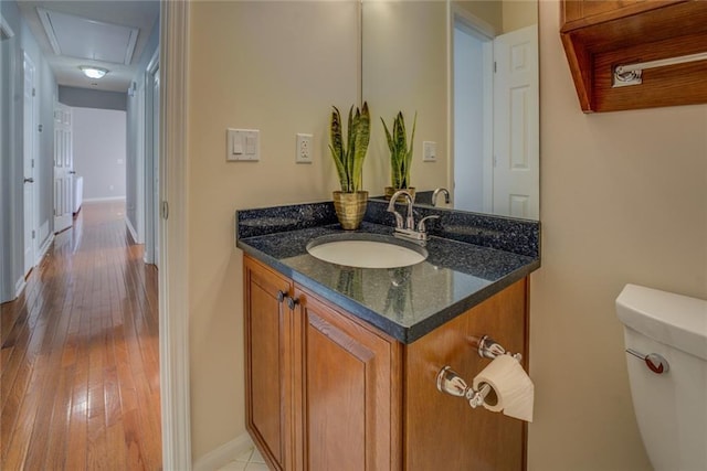 bathroom featuring hardwood / wood-style floors, vanity, and toilet