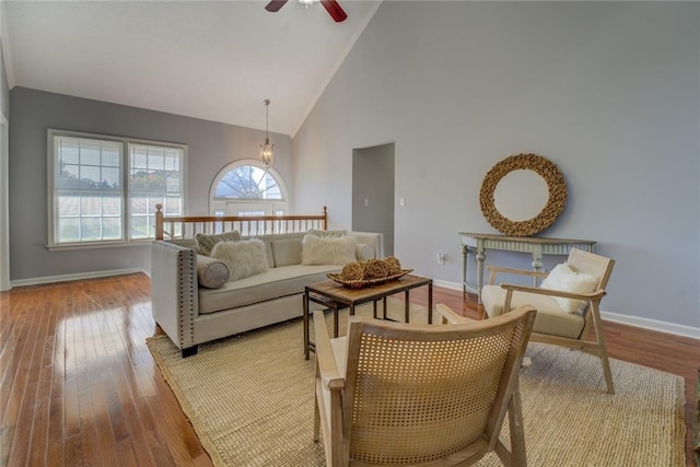 living room with light hardwood / wood-style floors, high vaulted ceiling, and ceiling fan