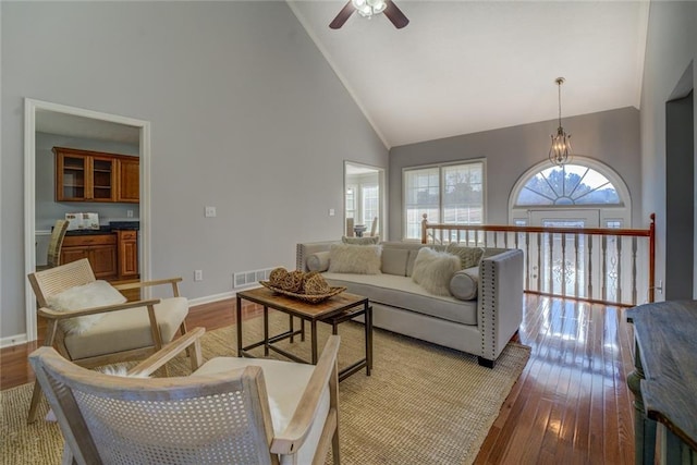 living room with light wood-type flooring, high vaulted ceiling, and ceiling fan