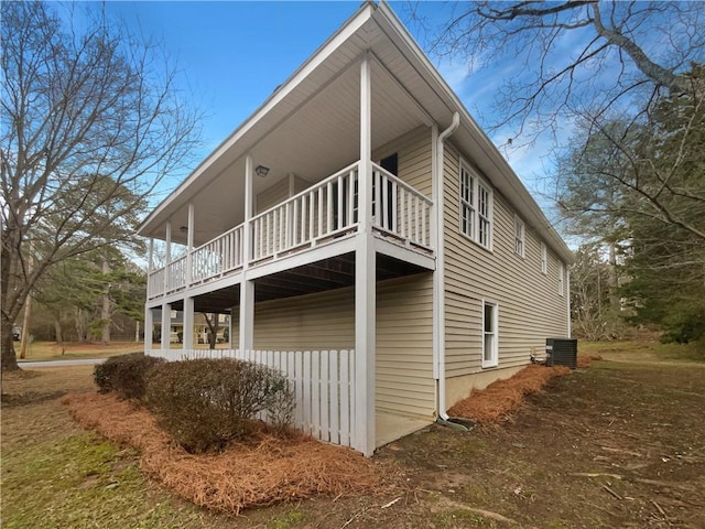 view of property exterior featuring central AC and a balcony