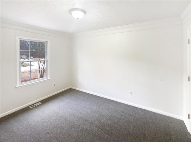 unfurnished room featuring baseboards, visible vents, ornamental molding, and dark colored carpet