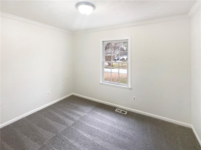 empty room with carpet floors, ornamental molding, visible vents, and baseboards