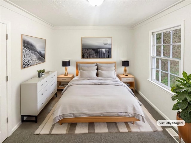 carpeted bedroom featuring baseboards and crown molding