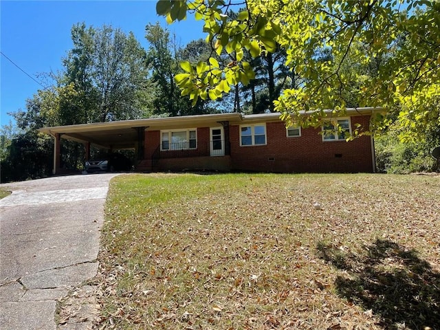 ranch-style house featuring a carport and a front yard