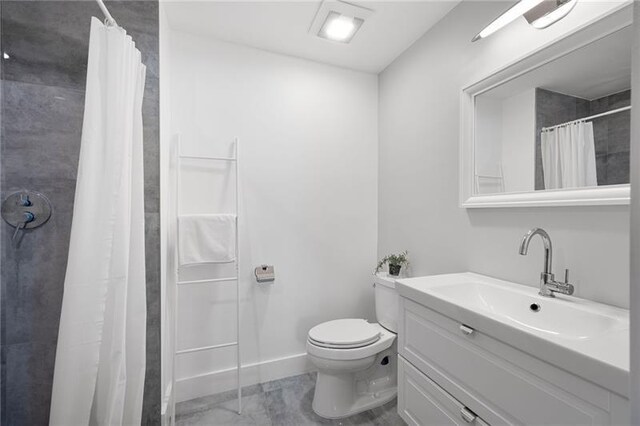 bathroom with a tile shower and vanity