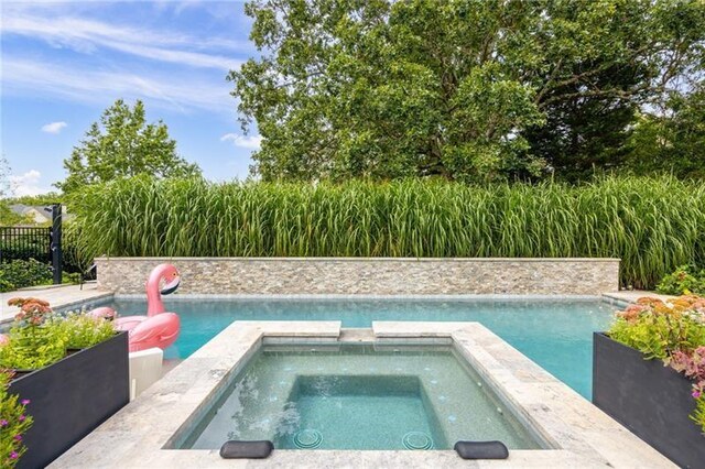 view of swimming pool with a patio area and an in ground hot tub