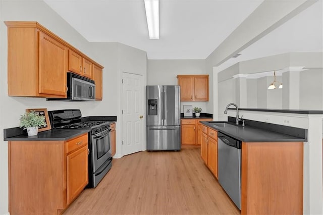 1795 Waterside Dr NW, Kennesaw, GA 30152 - kitchen featuring appliances with stainless steel finishes, sink, and light hardwood / wood-style flooring