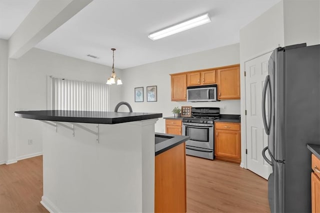 1795 Waterside Dr NW, Kennesaw, GA 30152 - kitchen with a kitchen bar, decorative light fixtures, appliances with stainless steel finishes, beamed ceiling, and light hardwood / wood-style floors