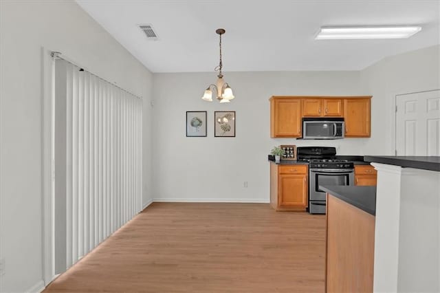 1795 Waterside Dr NW, Kennesaw, GA 30152 - kitchen featuring a notable chandelier, decorative light fixtures, light hardwood / wood-style flooring, and appliances with stainless steel finishes