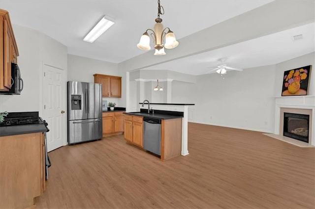 1795 Waterside Dr NW, Kennesaw, GA 30152 - kitchen featuring appliances with stainless steel finishes, decorative light fixtures, sink, light hardwood / wood-style floors, and a center island with sink