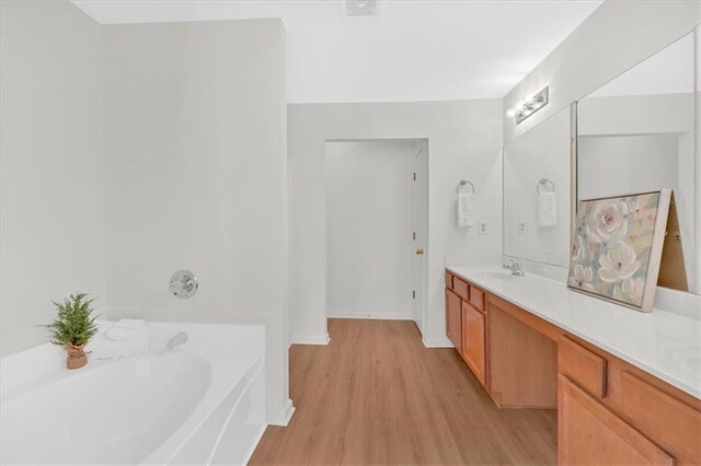 1795 Waterside Dr NW, Kennesaw, GA 30152 - bathroom featuring vanity, a tub to relax in, and hardwood / wood-style flooring