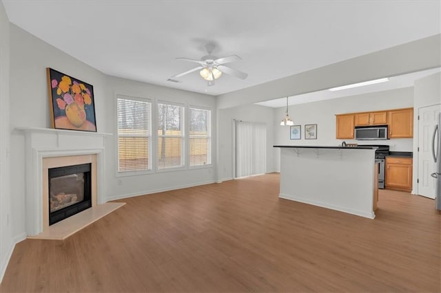 1795 Waterside Dr NW, Kennesaw, GA 30152 - unfurnished living room with ceiling fan and light hardwood / wood-style floors
