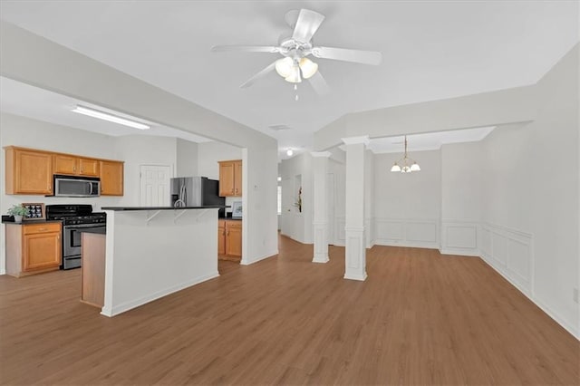 1795 Waterside Dr NW, Kennesaw, GA 30152 - kitchen featuring a kitchen island, pendant lighting, decorative columns, light hardwood / wood-style floors, and stainless steel appliances