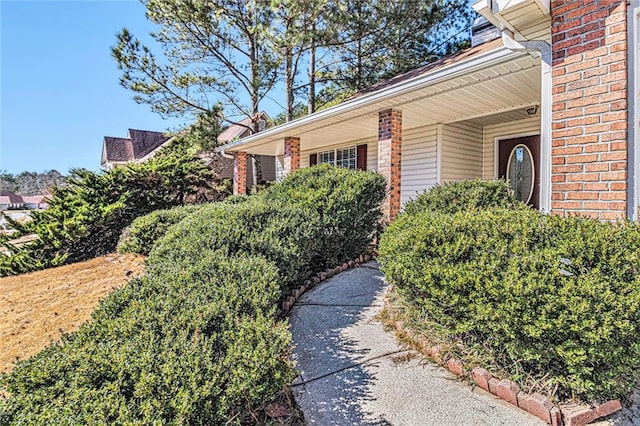 doorway to property with brick siding