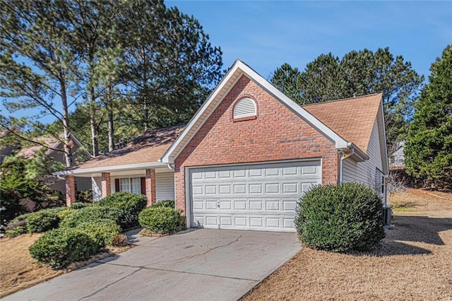 view of front of home with driveway, a garage, and brick siding