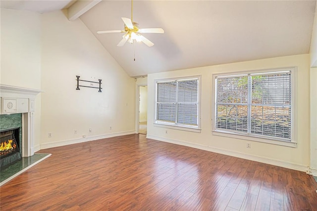 unfurnished living room featuring a ceiling fan, beamed ceiling, wood finished floors, high vaulted ceiling, and a high end fireplace