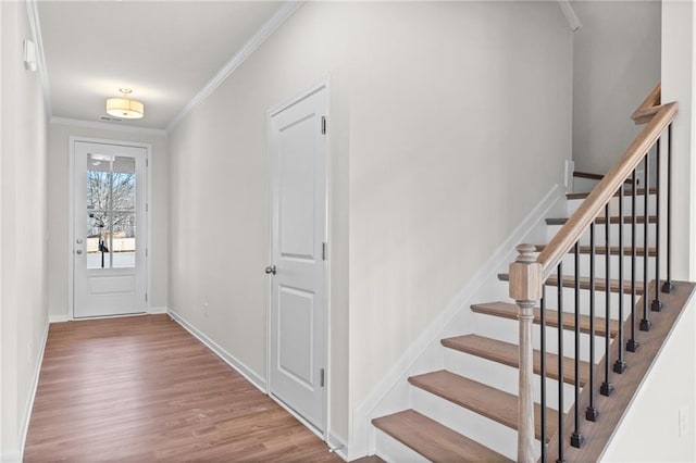 entrance foyer featuring light hardwood / wood-style flooring and ornamental molding