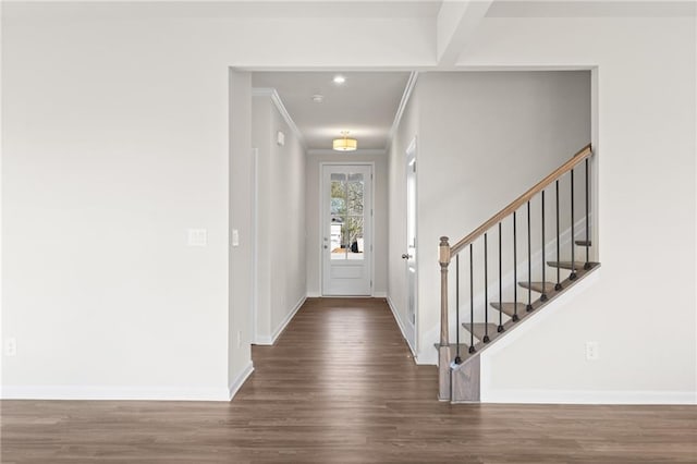 foyer featuring beamed ceiling, dark hardwood / wood-style floors, and ornamental molding