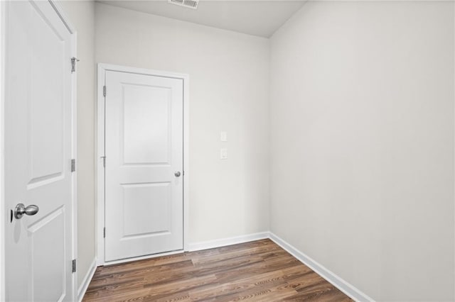 unfurnished room featuring dark wood-type flooring