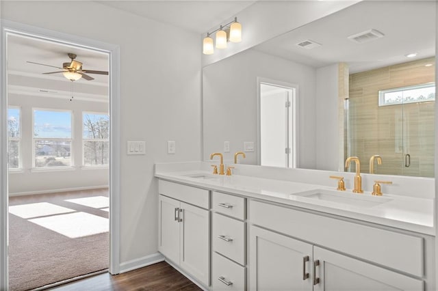 bathroom featuring ceiling fan, an enclosed shower, vanity, and a healthy amount of sunlight