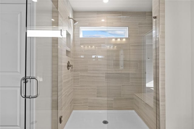 bathroom featuring a shower with shower door