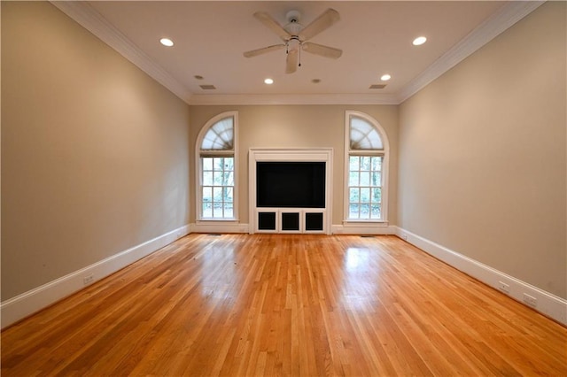 unfurnished living room featuring ceiling fan, ornamental molding, and light hardwood / wood-style flooring