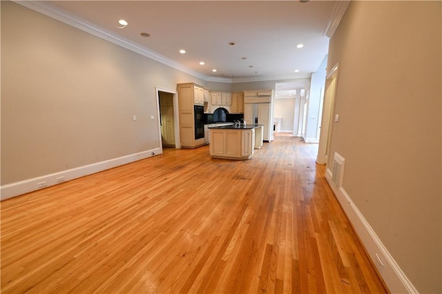 kitchen featuring paneled fridge, double oven, crown molding, light hardwood / wood-style floors, and a kitchen island