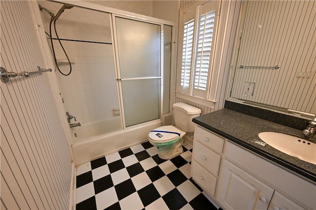 full bathroom featuring vanity, toilet, and shower / bath combination with glass door