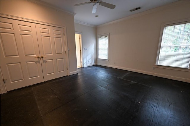entrance foyer with ceiling fan, crown molding, and a wealth of natural light