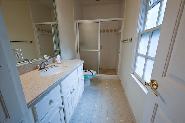 bathroom with plenty of natural light, toilet, an enclosed shower, and vanity