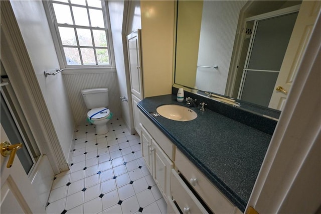 full bathroom featuring tile patterned flooring, vanity, toilet, and bath / shower combo with glass door