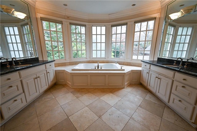 bathroom featuring tile patterned floors, a bathing tub, a wealth of natural light, and crown molding