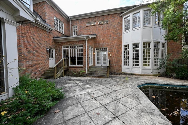 rear view of property featuring a patio area and french doors