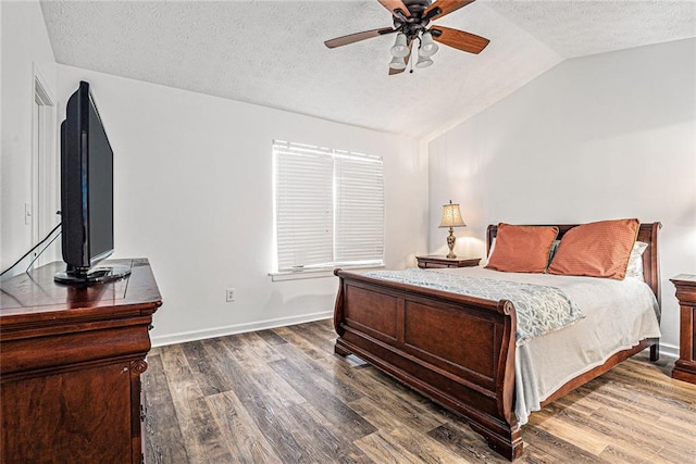 bedroom with ceiling fan, lofted ceiling, dark hardwood / wood-style floors, and a textured ceiling