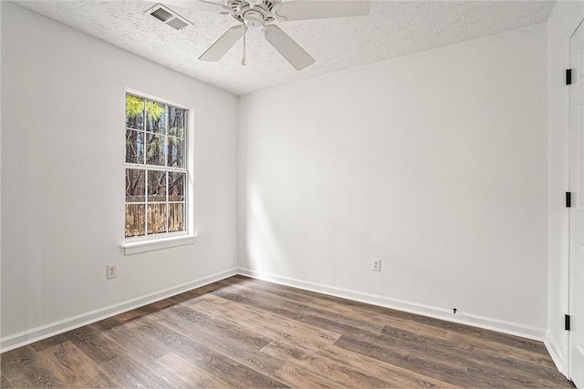 unfurnished room with dark hardwood / wood-style flooring, ceiling fan, and a textured ceiling