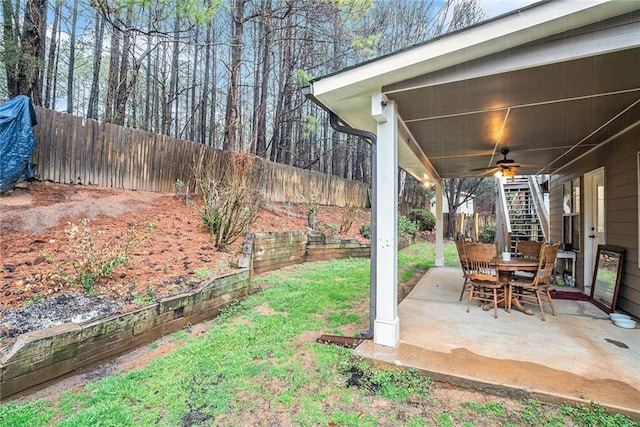 view of yard featuring a patio area and ceiling fan