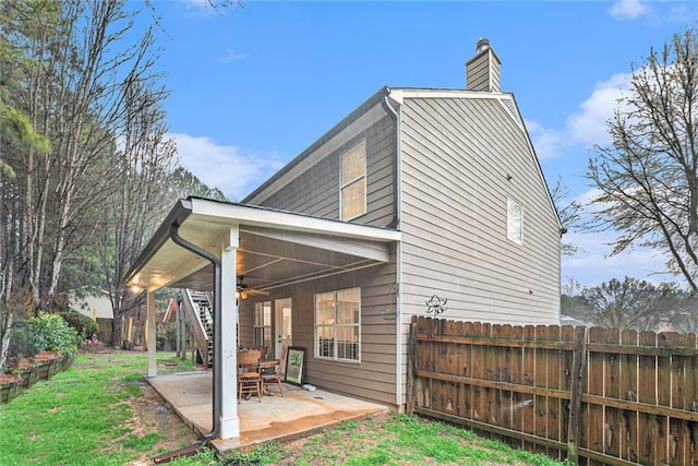 rear view of property with a yard and a patio