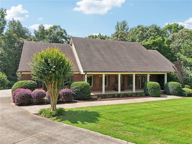 169 Robson Trl, Mcdonough, GA 30252 - view of front of home featuring brick siding, a porch, a front yard, and a shingled roof