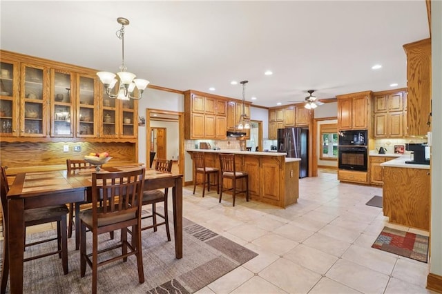 169 Robson Trl, Mcdonough, GA 30252 - dining room with recessed lighting, ceiling fan, light tile patterned floors, a chandelier, and ornamental molding