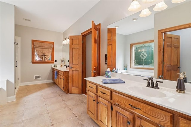 169 Robson Trl, Mcdonough, GA 30252 - bathroom featuring vanity, a garden tub, and tile patterned floors