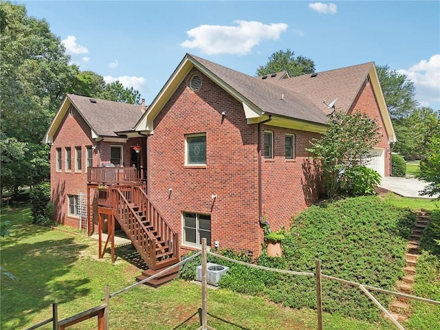 169 Robson Trl, Mcdonough, GA 30252 - rear view of house with brick siding, driveway, roof with shingles, and stairs