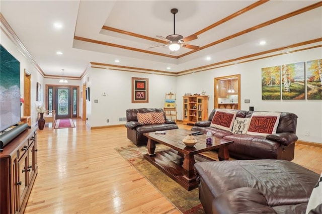 169 Robson Trl, Mcdonough, GA 30252 - living room featuring a tray ceiling, crown molding, ceiling fan, light wood-style floors, and recessed lighting