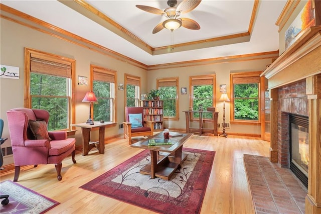 169 Robson Trl, Mcdonough, GA 30252 - living room with a brick fireplace, a raised ceiling, ornamental molding, wood finished floors, and ceiling fan
