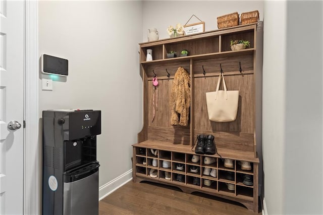 mudroom featuring dark wood-style flooring and baseboards