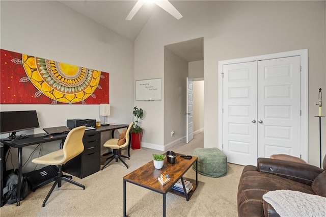 carpeted office space featuring high vaulted ceiling, ceiling fan, and baseboards