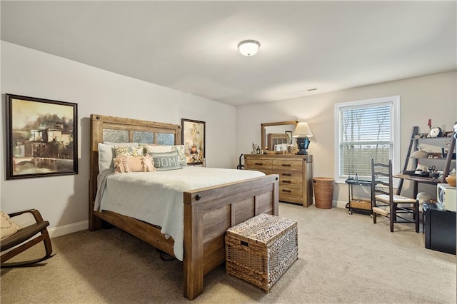 bedroom featuring light carpet and baseboards