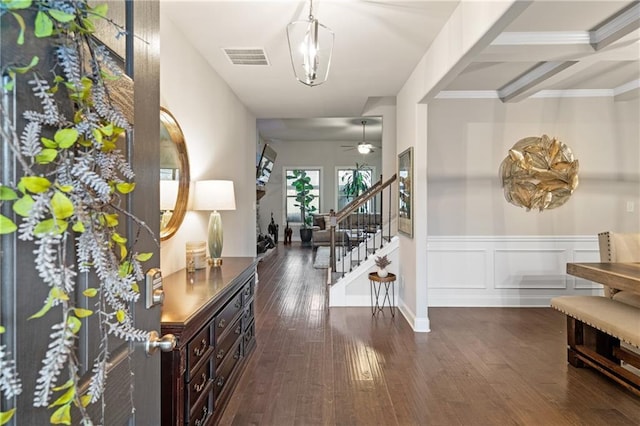 entryway featuring visible vents, a ceiling fan, wainscoting, dark wood-type flooring, and stairs